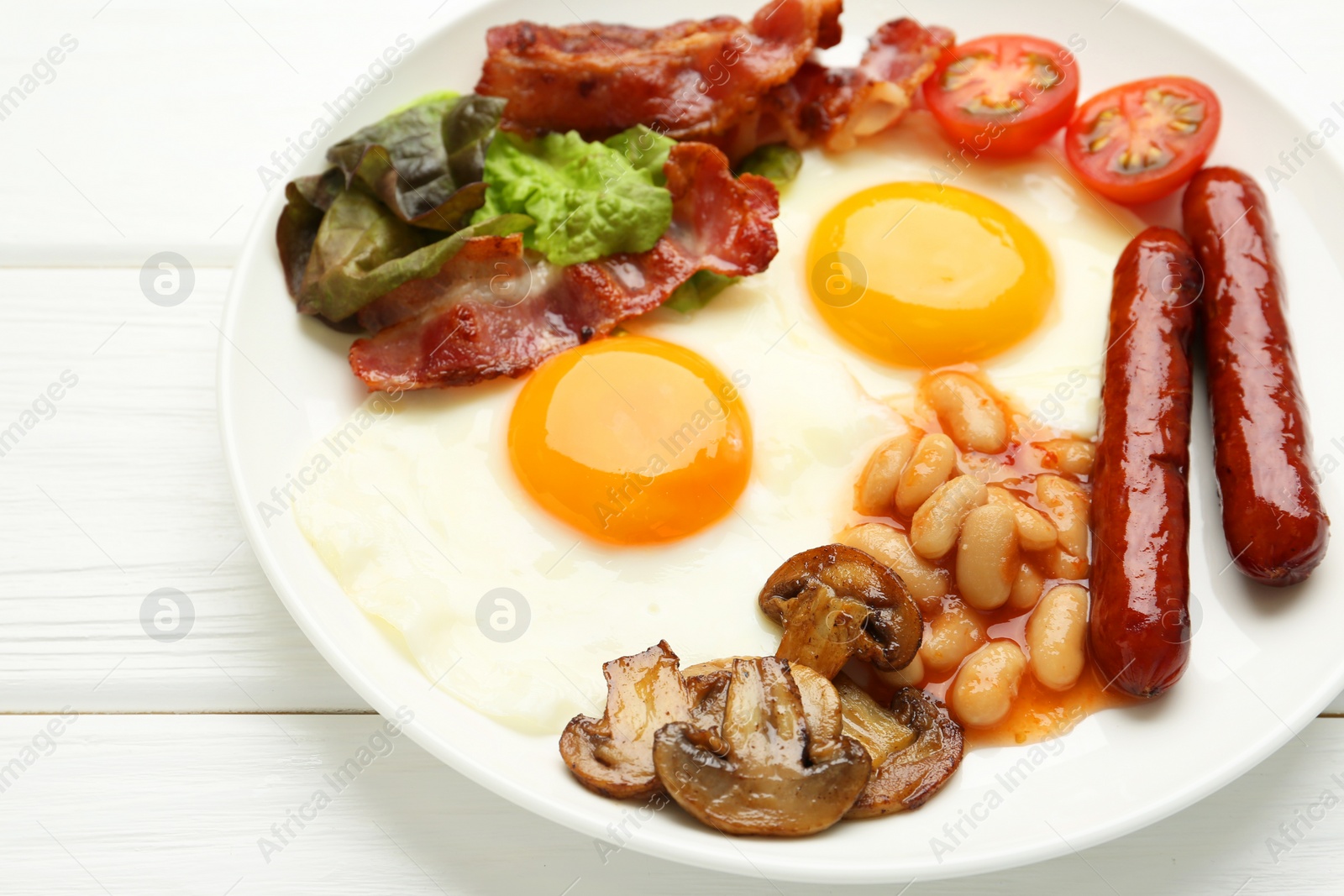 Photo of Delicious breakfast with sunny side up eggs on white wooden table, closeup