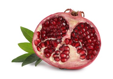 Photo of Ripe fresh pomegranate half with juicy seeds and green leaves on white background
