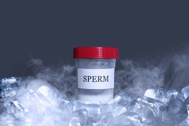 Image of Cryopreservation. Container with sperm and ice cubes on grey background. Frost effect