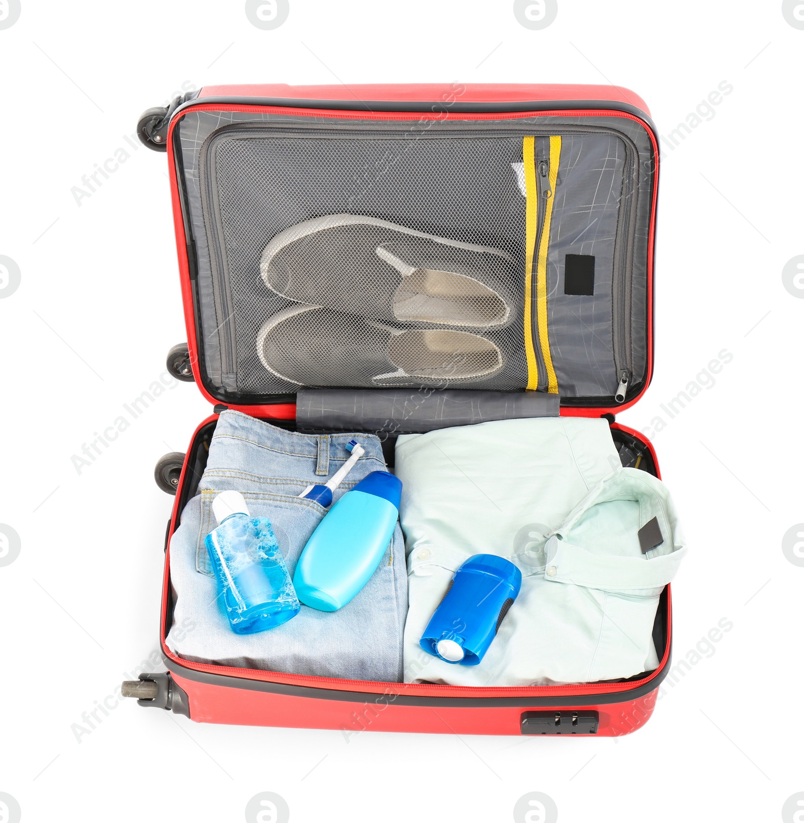 Photo of Packed suitcase with deodorant and clothes on white background