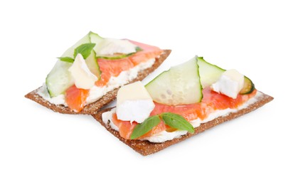 Photo of Tasty rye crispbreads with salmon, cream cheese and cucumber isolated on white
