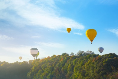 Photo of Beautiful view of hot air balloons flying over autumn forest