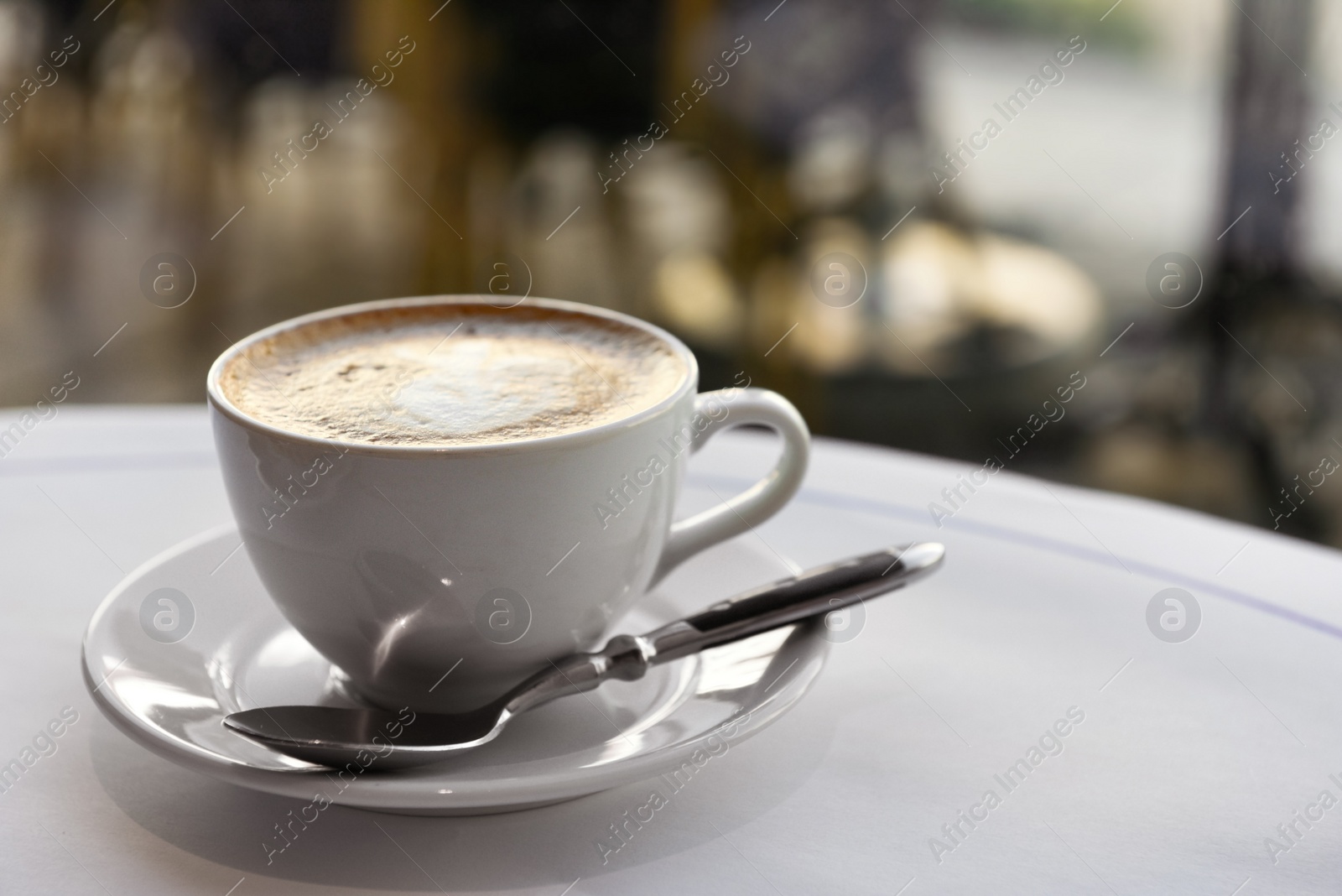 Photo of Cup of fresh coffee on table in morning, space for text