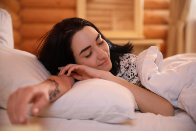 Photo of Young woman sleeping in bed at home. Lazy morning