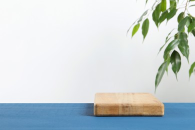 Photo of Board on blue wooden table. Space for text