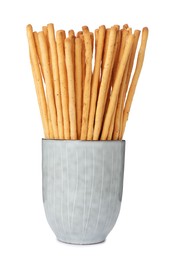 Delicious grissini sticks in cup on white background