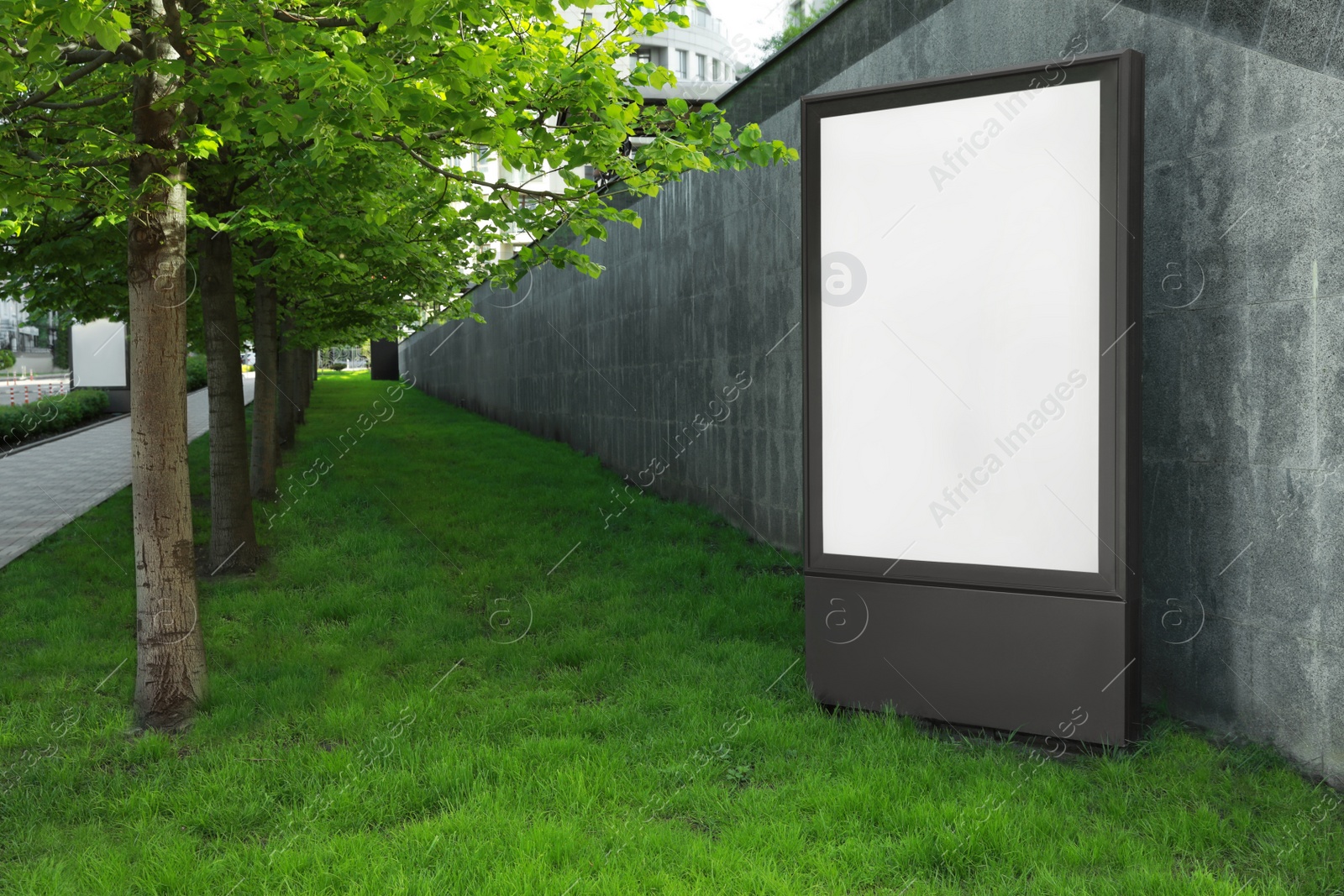 Photo of Blank advertising board on city street. Mockup for design