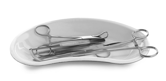 Surgical instruments in kidney dish on white background
