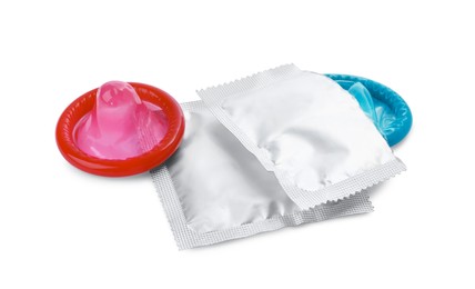 Photo of Unpacked condom and packages on white background. Safe sex
