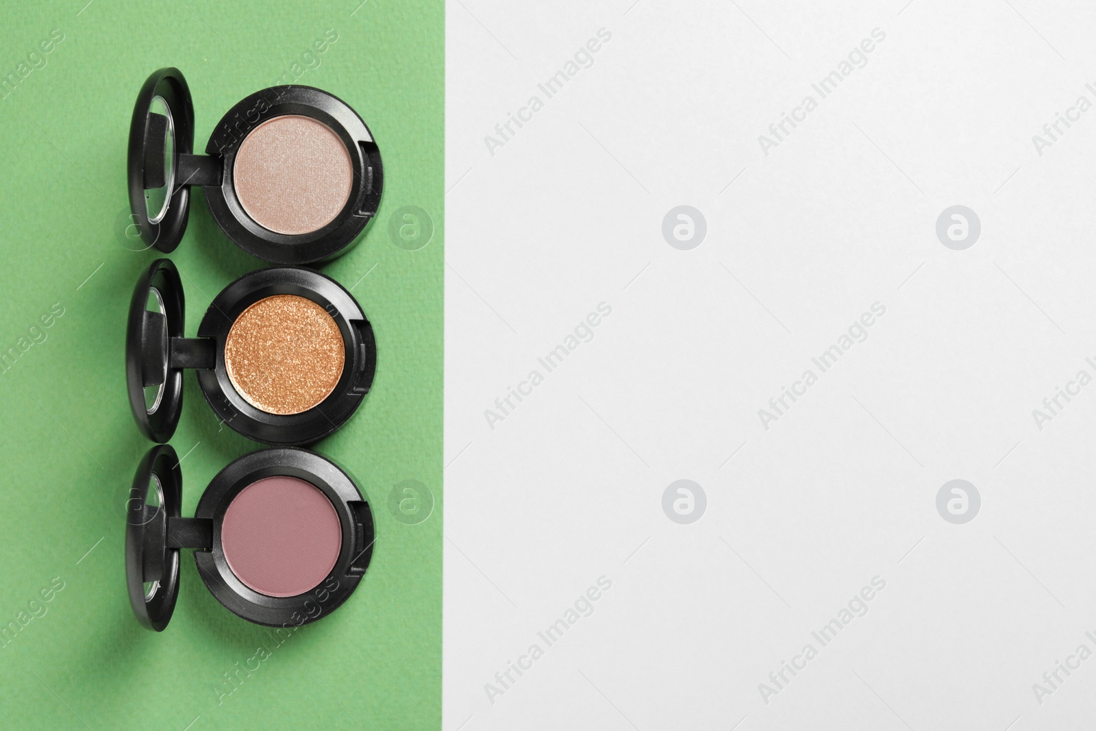 Photo of Flat lay composition with different eye shadows on color background. Space for text