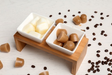 Composition with milk and coffee ice cubes on white wooden table