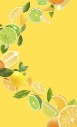 Image of Fresh juicy citrus fruits and green leaves falling on yellow background
