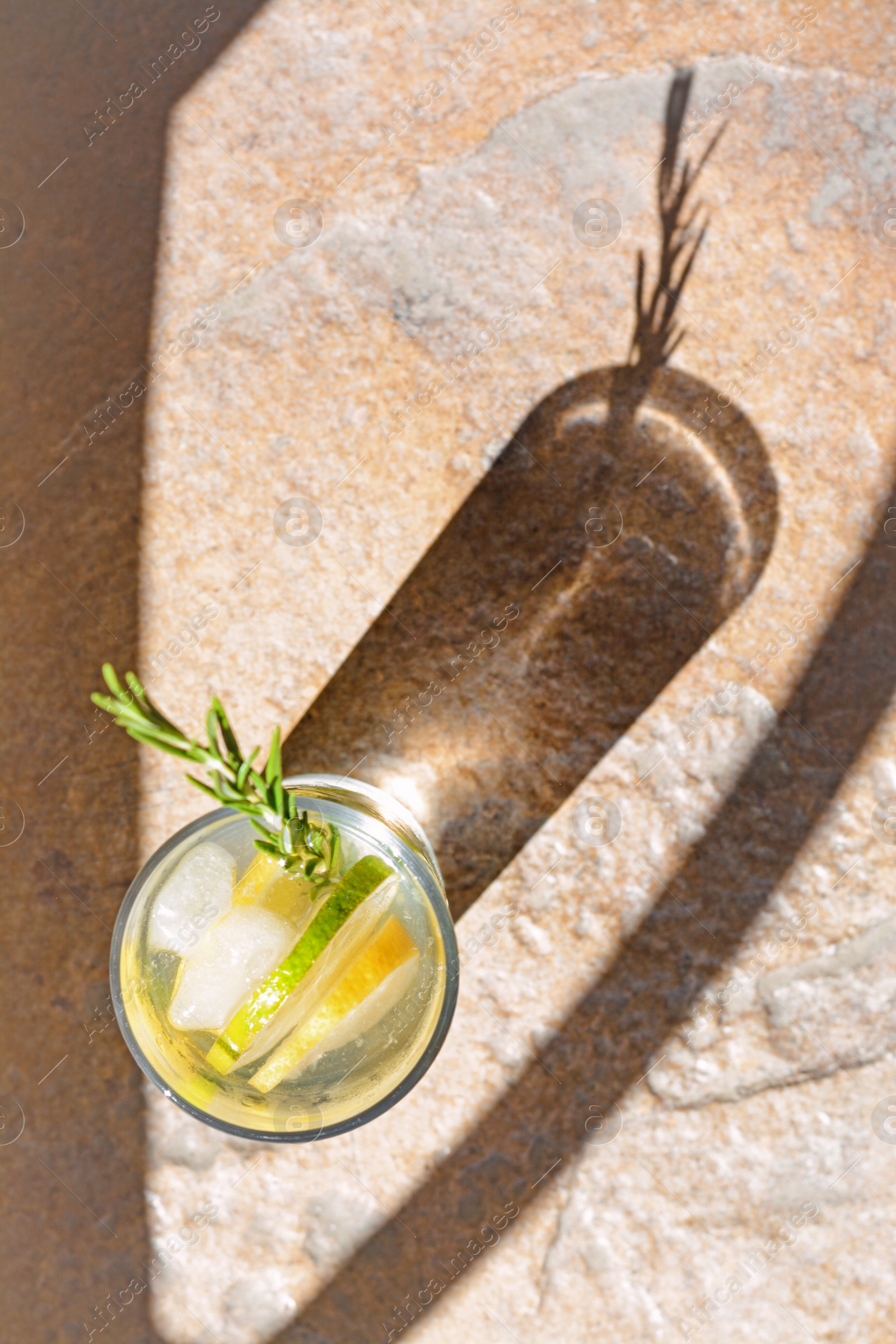 Photo of Summer refreshing lemonade on light brown table, top view. Space for text