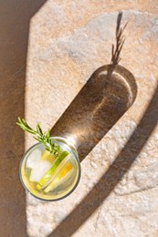 Photo of Summer refreshing lemonade on light brown table, top view. Space for text