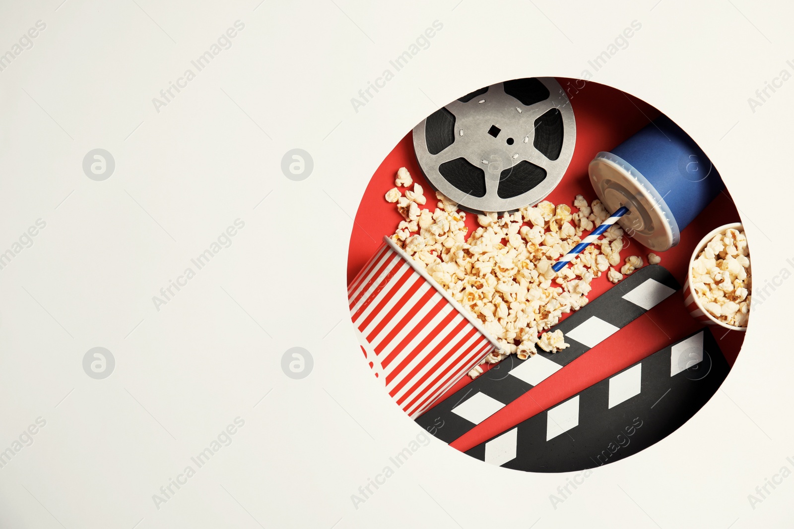 Photo of Composition with popcorn, cinema reel and space for text on color background, top view