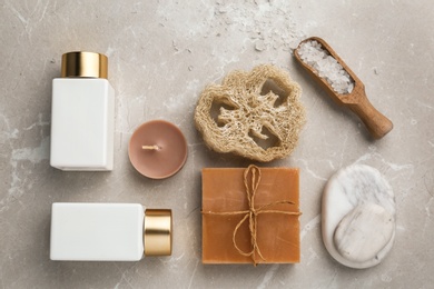 Flat lay composition with spa supplies on stone table