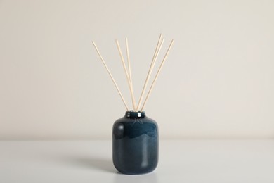 Photo of Aromatic reed air freshener on white background