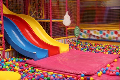 Slides and many colorful balls in ball pit