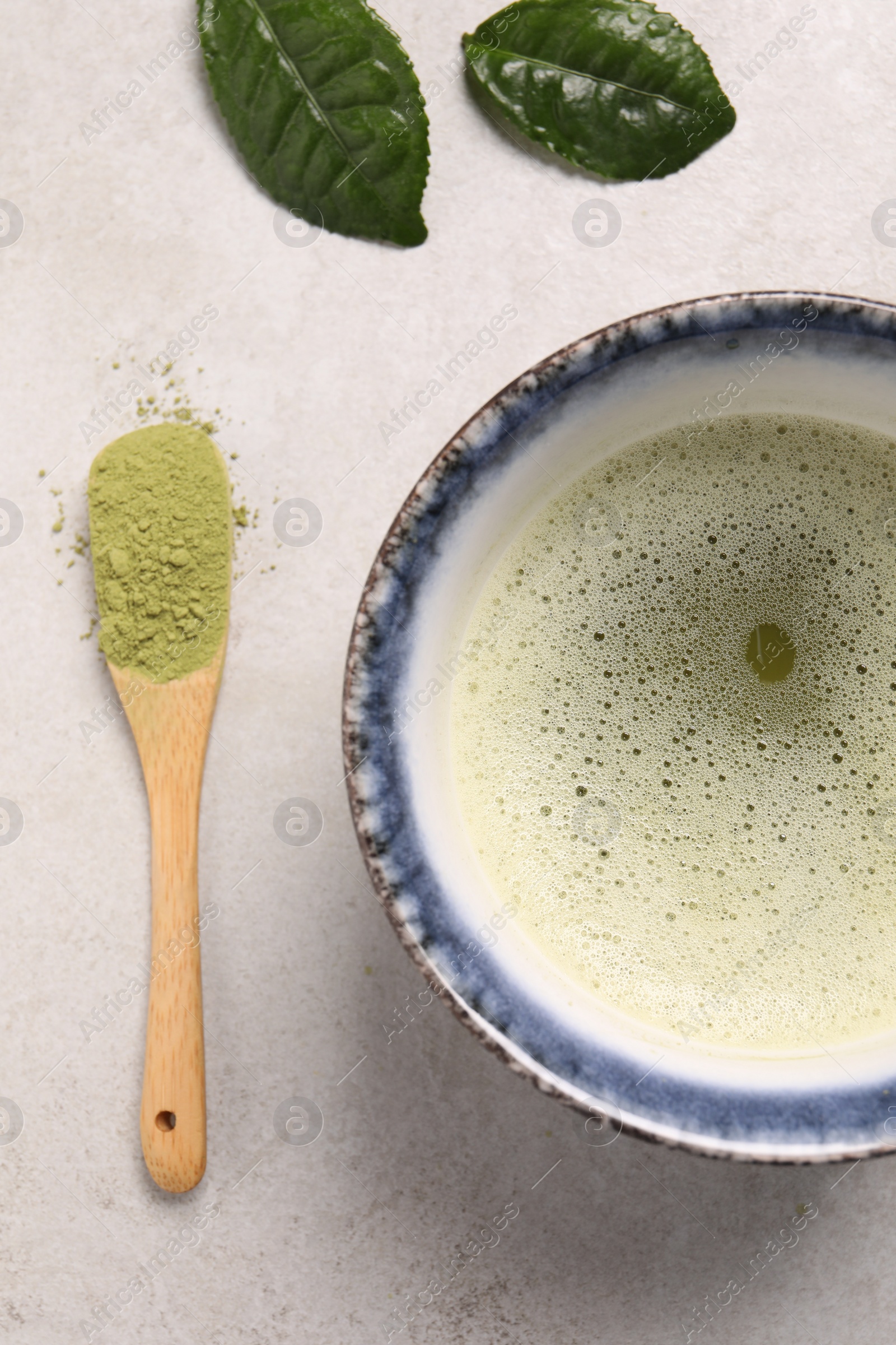 Photo of Flat lay composition with matcha tea on light gray textured table