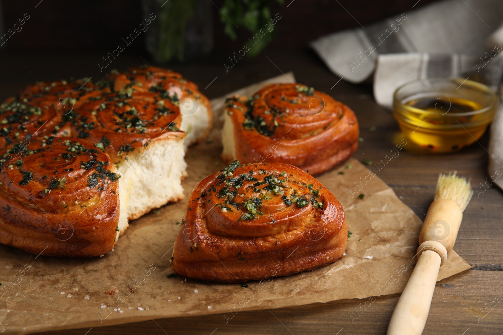 Photo of Traditional Ukrainian bread (Pampushky) with garlic on wooden table