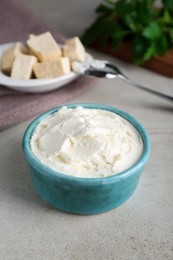 Photo of Delicious tofu cream cheese in bowl on light table, closeup