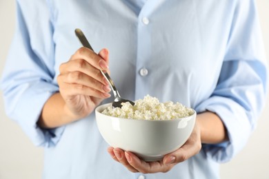 Woman with bowl of cottage cheese, closeup