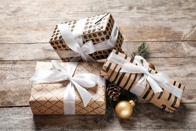 Photo of Beautiful composition with gift box and Christmas decorations on wooden table