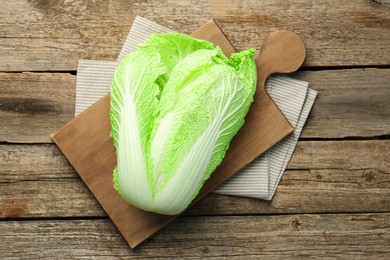 Photo of Fresh ripe Chinese cabbage on wooden table, top view