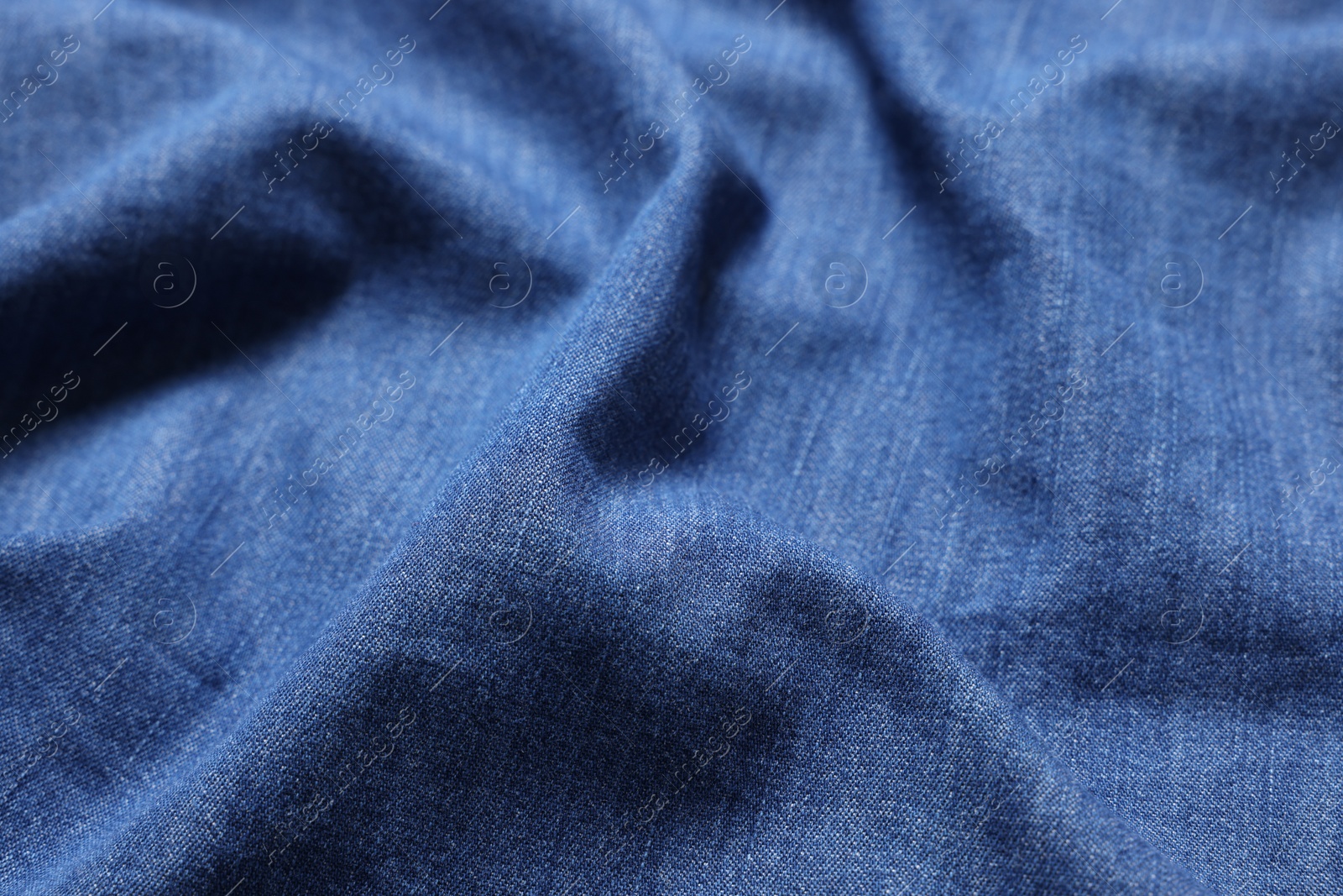 Photo of Texture of blue crumpled fabric as background, closeup