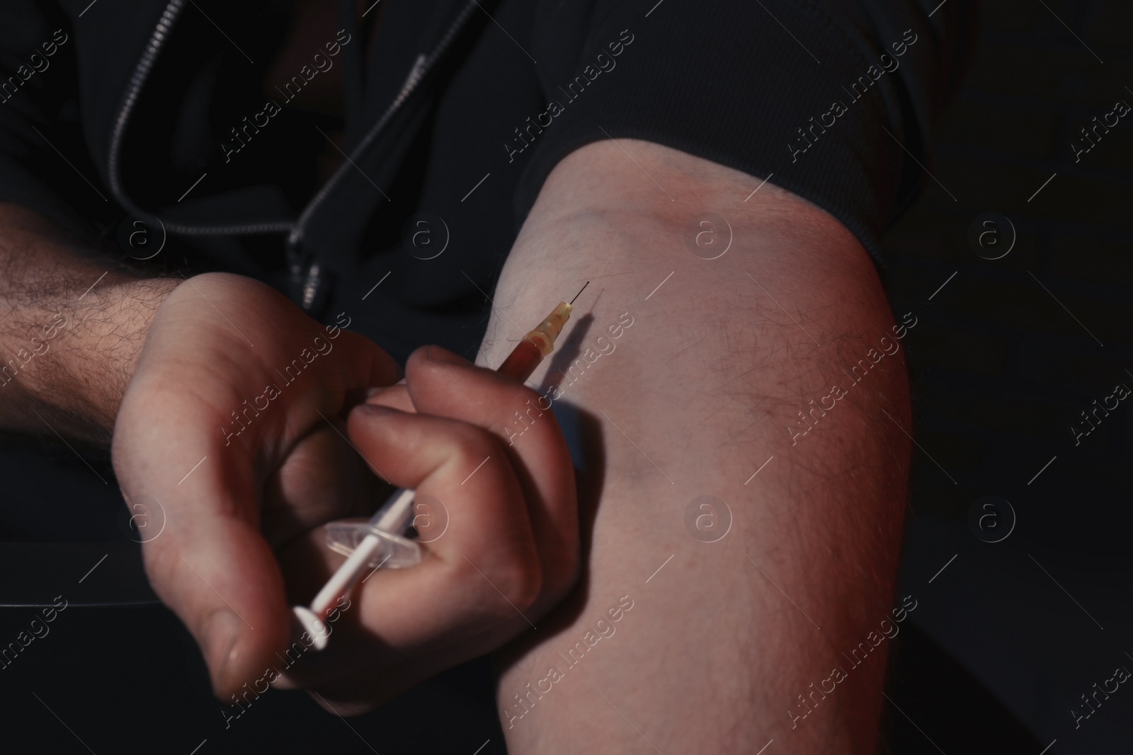 Photo of Man taking drugs on dark background, closeup