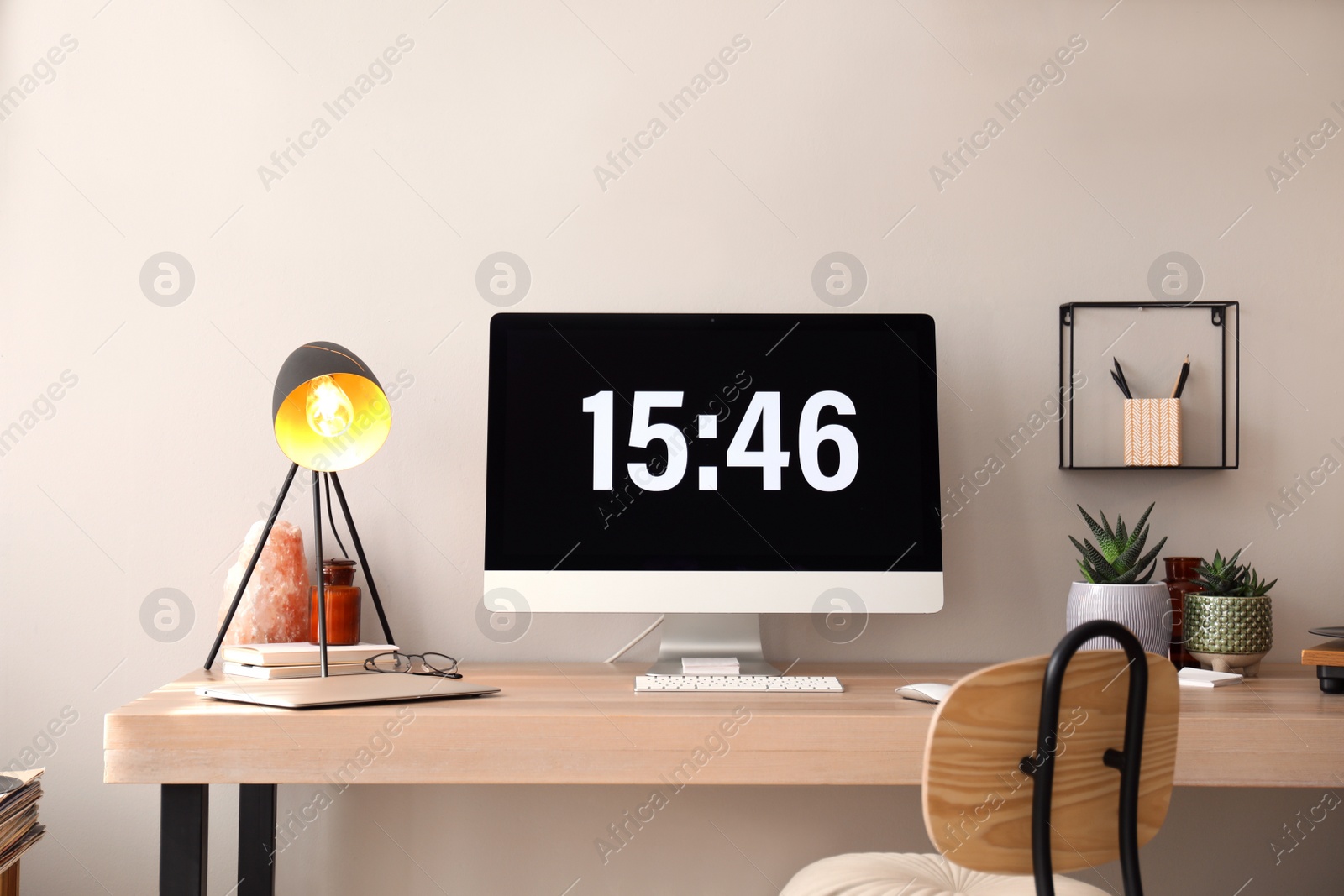 Photo of Modern computer and laptop on wooden desk in room. Interior design