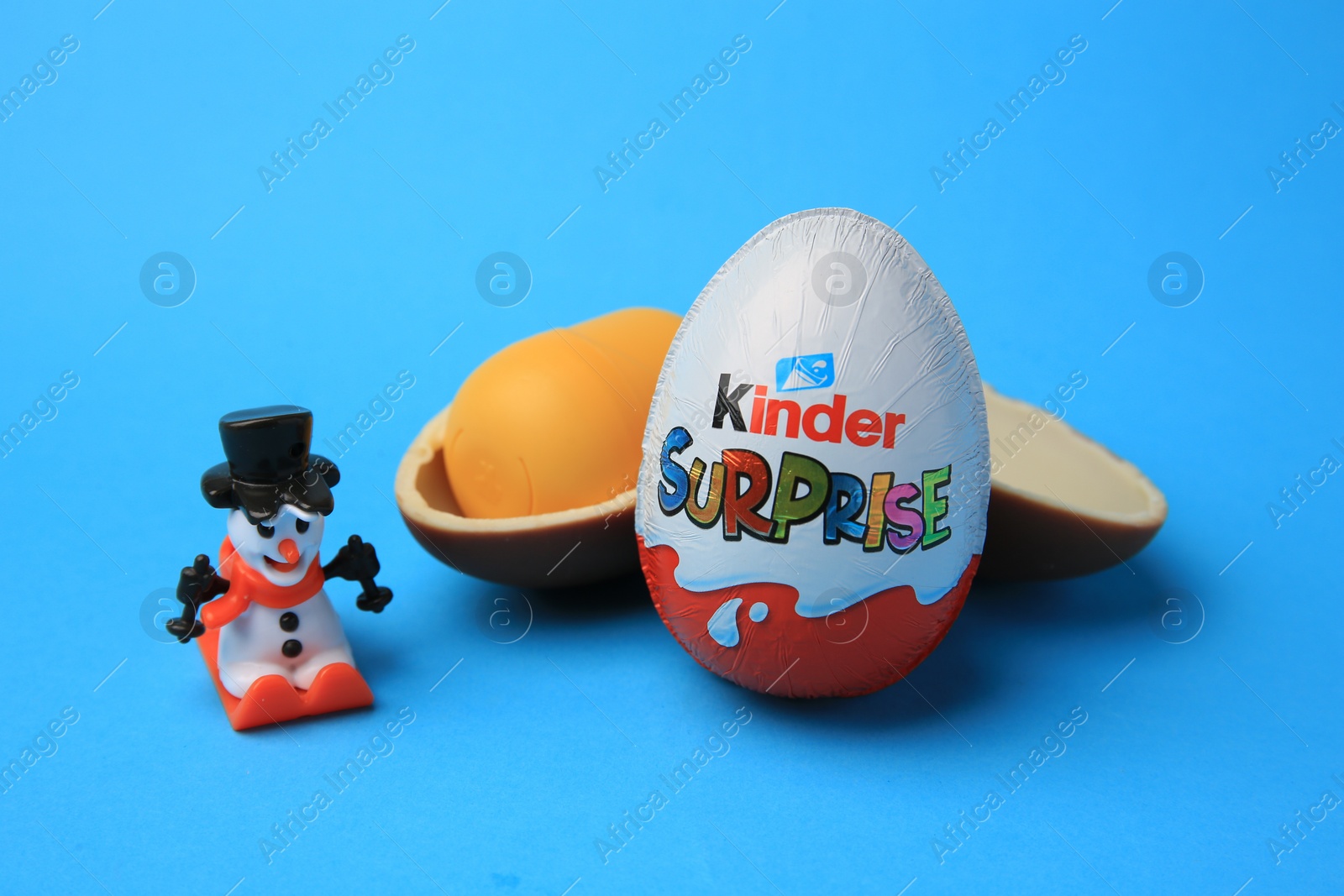 Photo of Sveti Vlas, Bulgaria - June 29, 2023: Kinder Surprise Eggs, plastic capsule and toy on light blue background