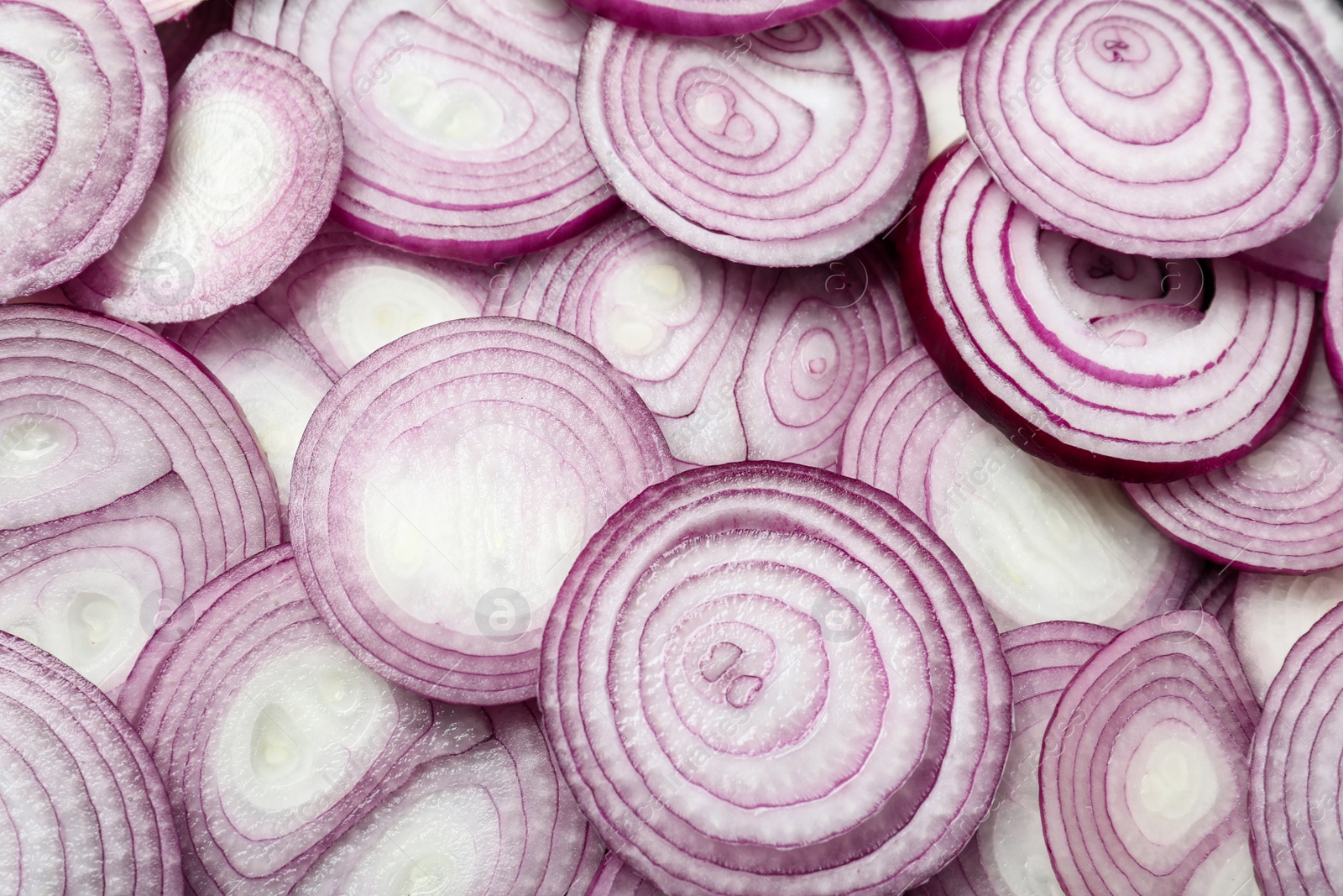 Photo of Cut fresh red onions as background, top view