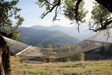 Comfortable net hammock in mountains on sunny day