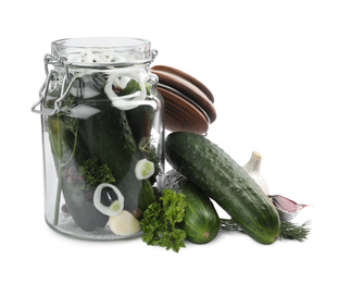 Photo of Pickling jar with fresh ripe cucumbers isolated on white