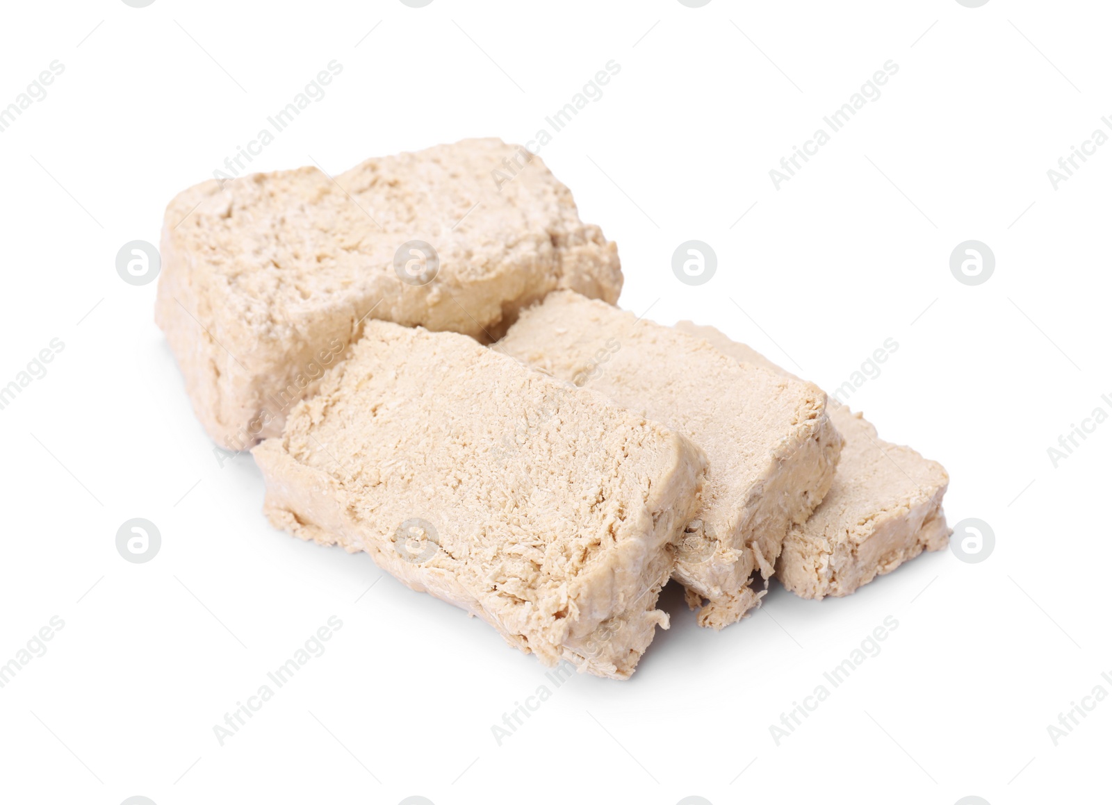 Photo of Pieces of tasty halva isolated on white