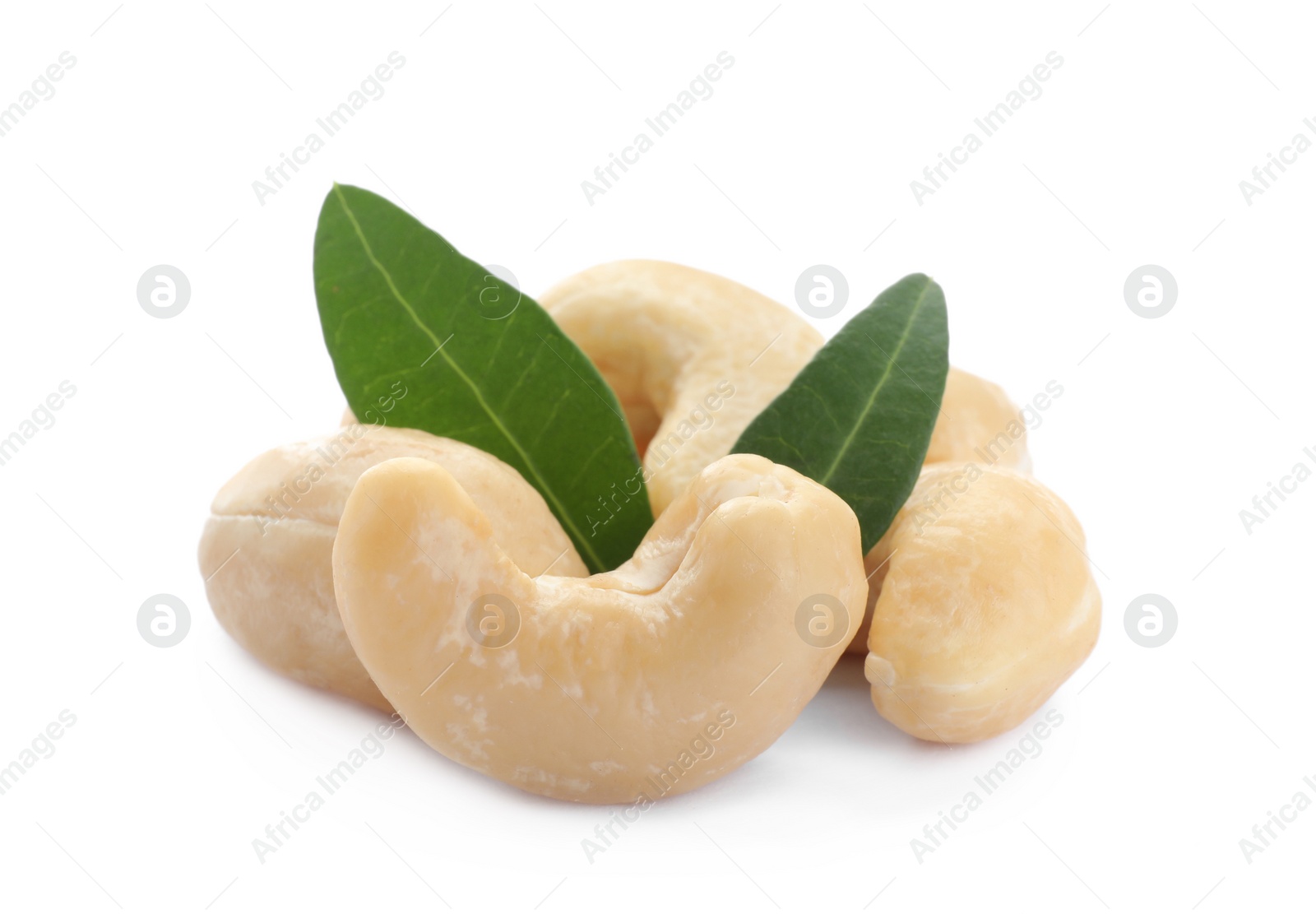 Photo of Tasty organic cashew nuts and green leaves isolated on white