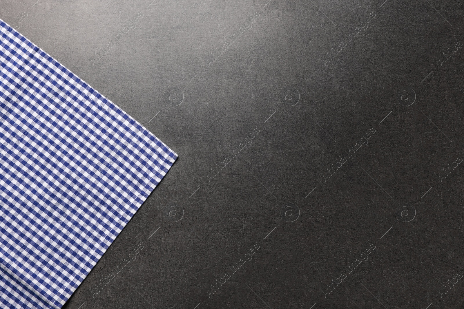 Photo of Checkered tablecloth on grey background, top view. Space for text