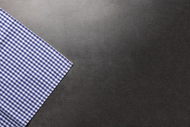 Photo of Checkered tablecloth on grey background, top view. Space for text