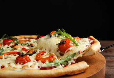 Photo of Delicious seafood pizza on wooden board, closeup