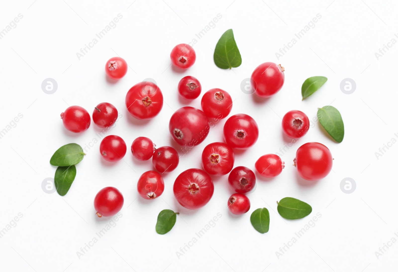 Photo of Fresh ripe cranberries and green leaves on white background, flat lay