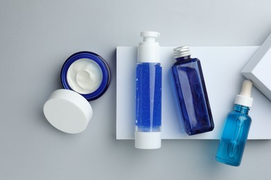 Photo of Set of cosmetic products on light grey background, flat lay