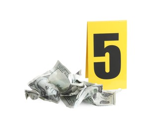 Photo of Bloody crumpled dollars and crime scene marker with number five isolated on white