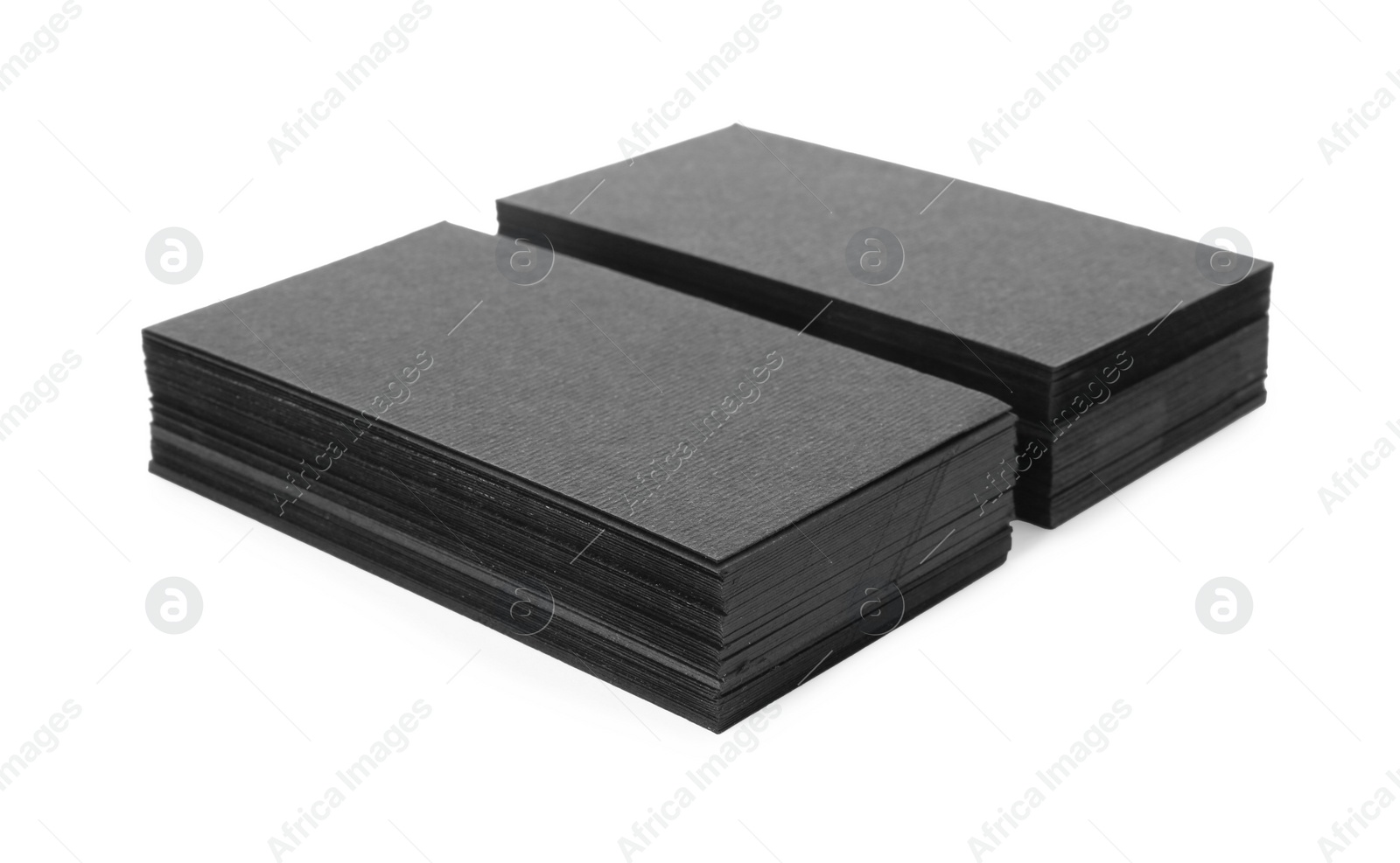 Photo of Stacks of blank black business cards isolated on white. Mockup for design