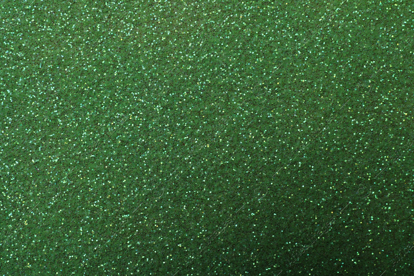 Photo of Beautiful shiny green glitter as background, closeup