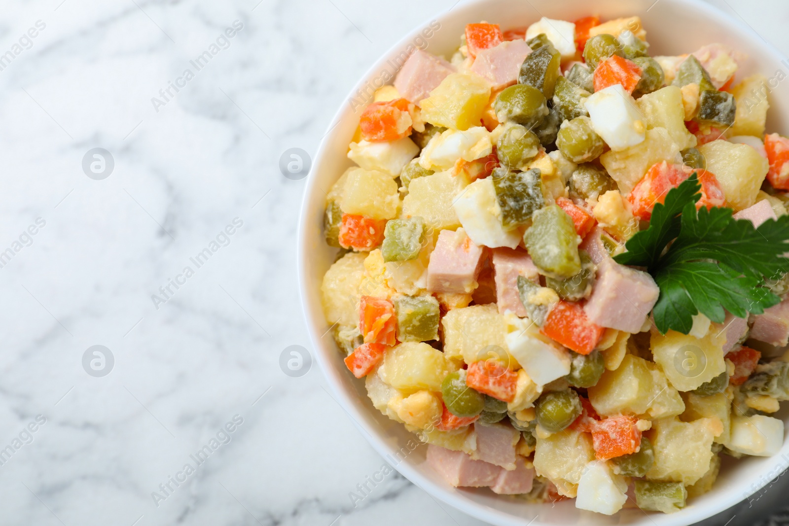 Photo of Delicious salad Olivier on marble table, top view. Space for text