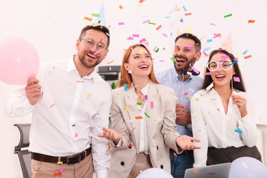 Photo of Coworkers having fun during office party indoors