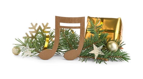 Photo of Wooden music note with fir tree branches and Christmas decor on white background