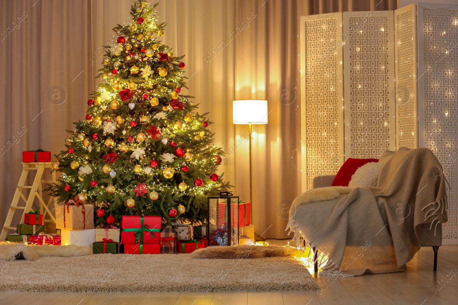 Photo of Beautifully wrapped gifts under Christmas tree in living room. Festive interior design