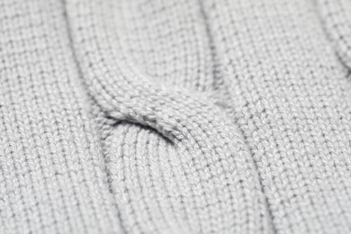 Texture of soft light knitted fabric as background, closeup